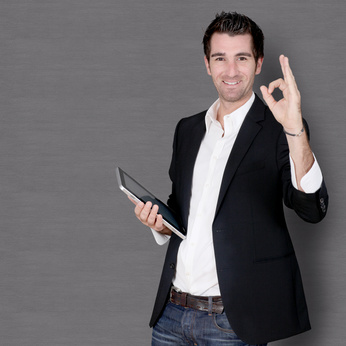 Smiling man standing on dark background