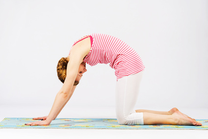 Beautiful woman doing cat yoga pose